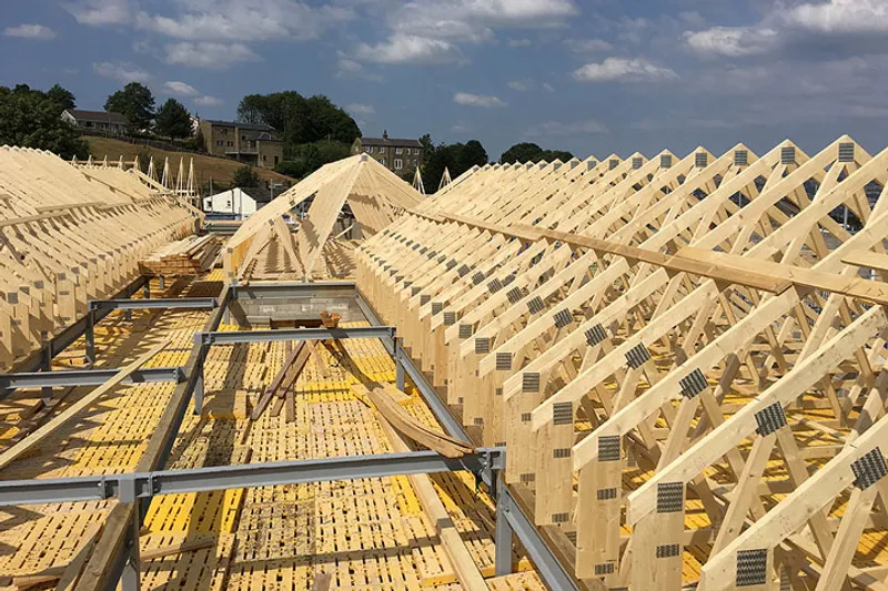 Commercial roof trusses installed with crane assistance 