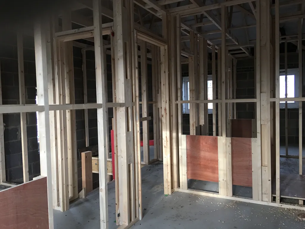 Timber stud wall frame construction in progress showing vertical studs and noggins in Thorp-arch 