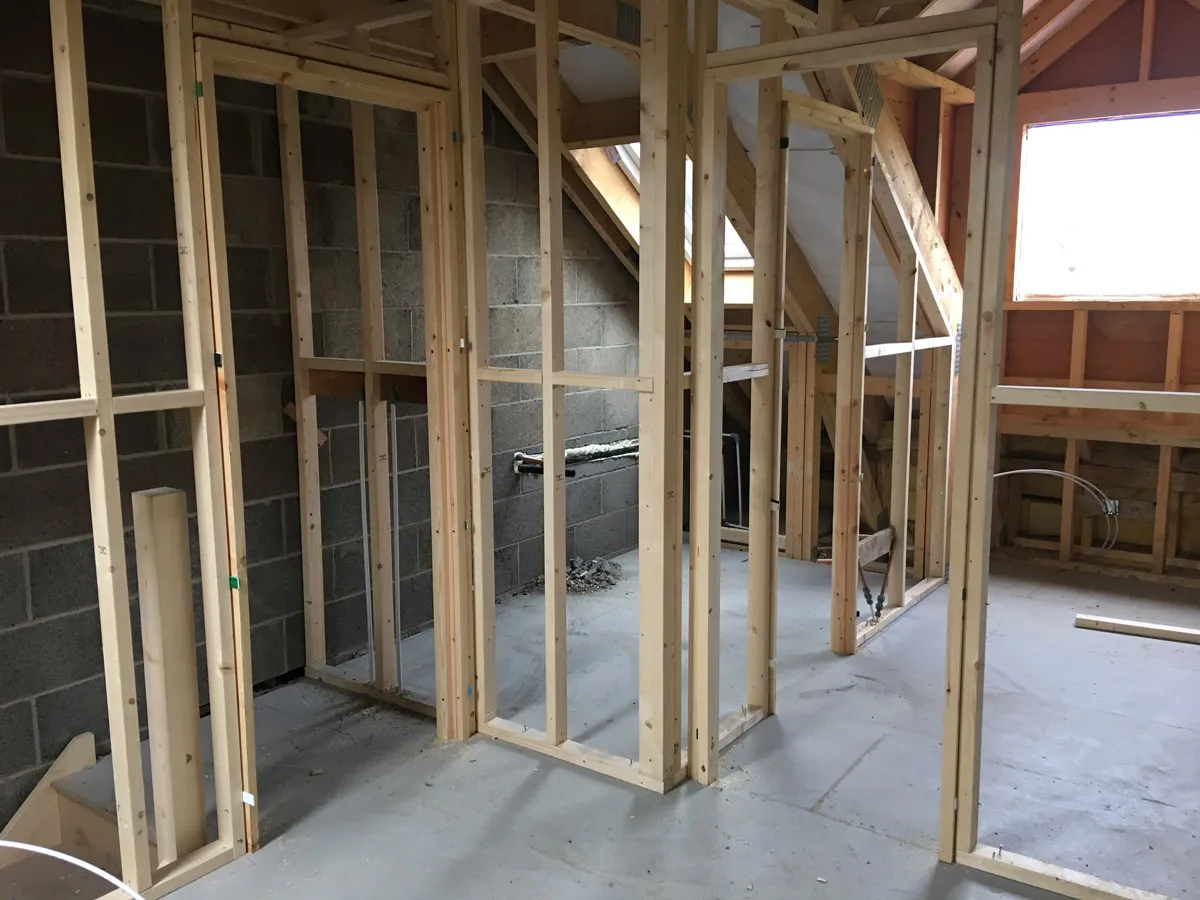 Completed timber partition wall with door opening prepared for plasterboard finish in Thorp-arch 